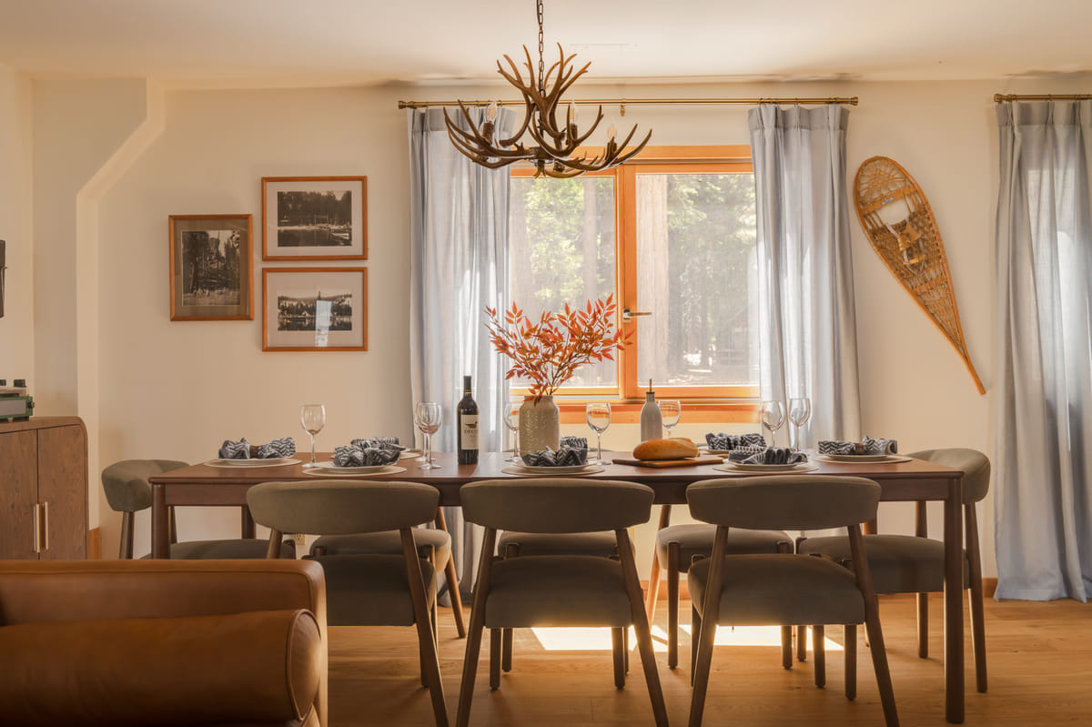 The dining table set under the antler chandelier